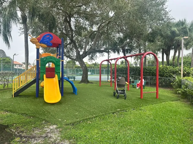 a childrens park with lots of swings and slides