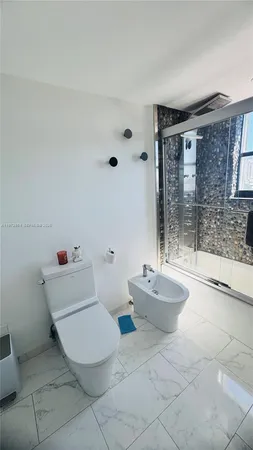 a bathroom with a sink mirror and toilet