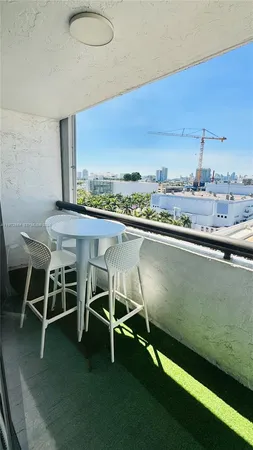 a view of a room with a table and chairs