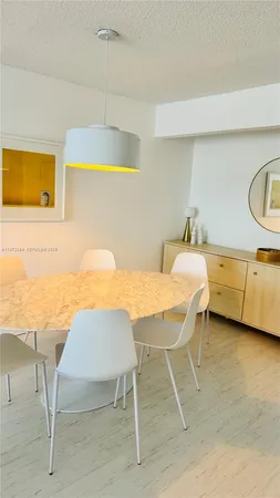 a view of a dining room with furniture and a chandelier