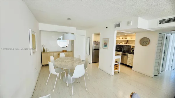 a view of a dining room with furniture and a chandelier
