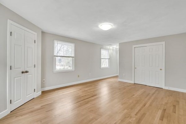 71 Smith Street Wellesley, MA 02482 - Photo 12 of 25 a view of an empty room with wooden floor and a window