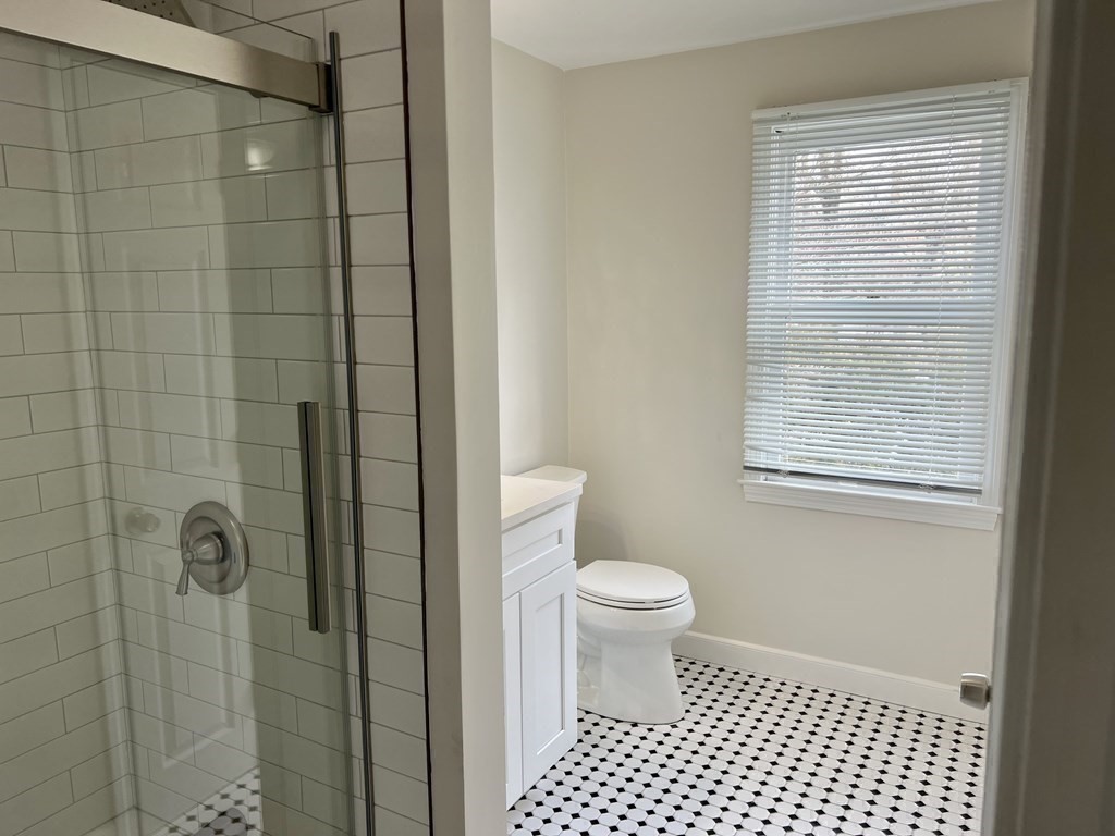 71 Smith Street Wellesley, MA 02482 - Photo 20 of 25 a bathroom with a toilet a window and shower