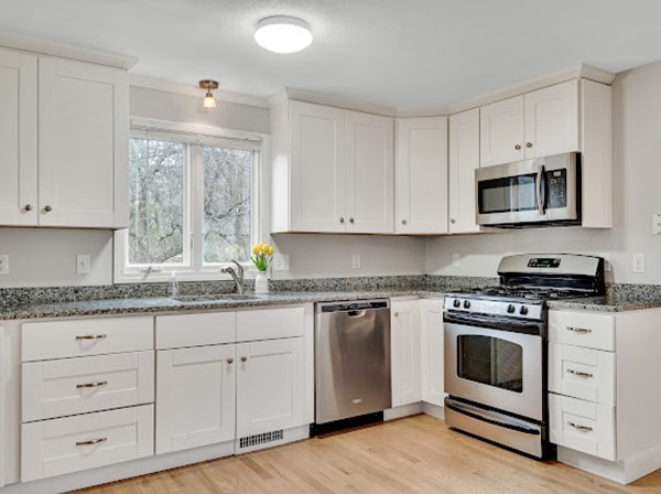 71 Smith Street Wellesley, MA 02482 - Photo 2 of 25 a kitchen with granite countertop white cabinets and appliances