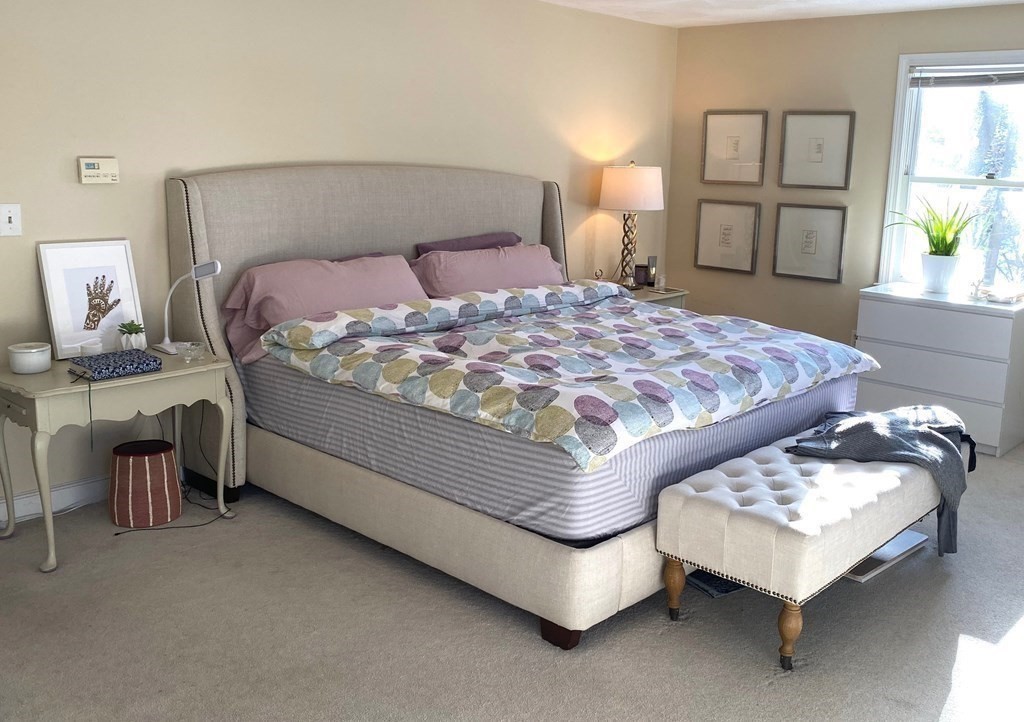 71 Smith Street Wellesley, MA 02482 - Photo 9 of 25 a bedroom with a bed paintings on wall and a window
