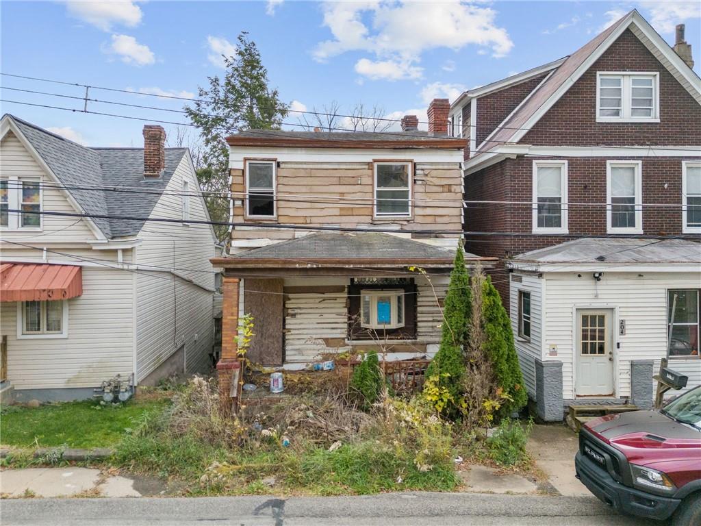 206 Alries Street Pittsburgh, PA 15210 - Photo 8 of 8 a front view of a house with a yard