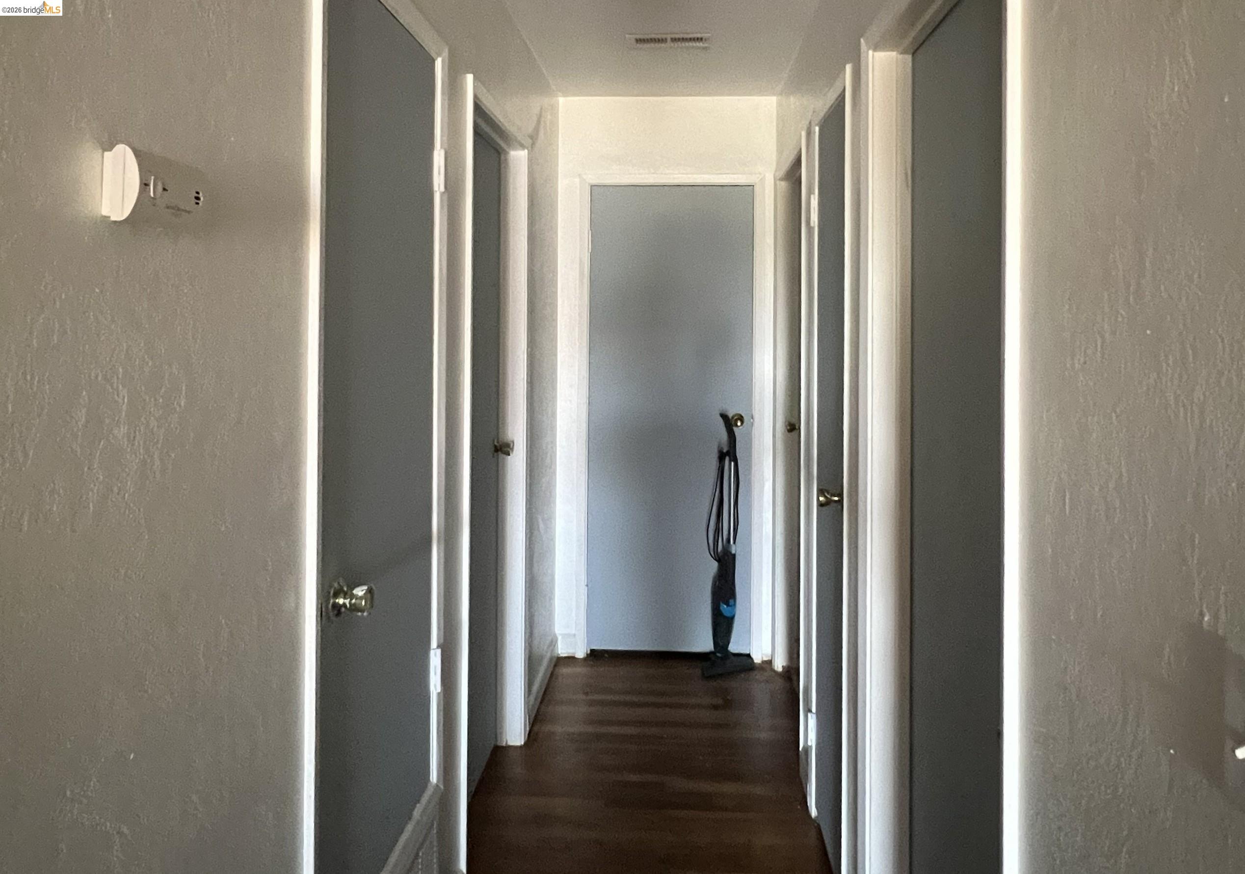 190 Tahoe Drive Rio Vista, CA 94571 - Photo 12 of 44 Corridor with a textured wall and dark wood-style floors