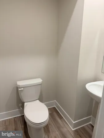 a white toilet sitting next to a shower