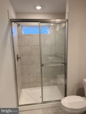 a bathroom with a shower a toilet and a sink