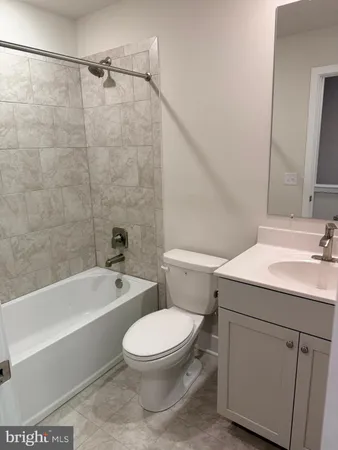 a bathroom with a toilet a sink and bathtub
