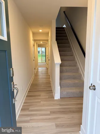 a view of entryway and hall with wooden floor