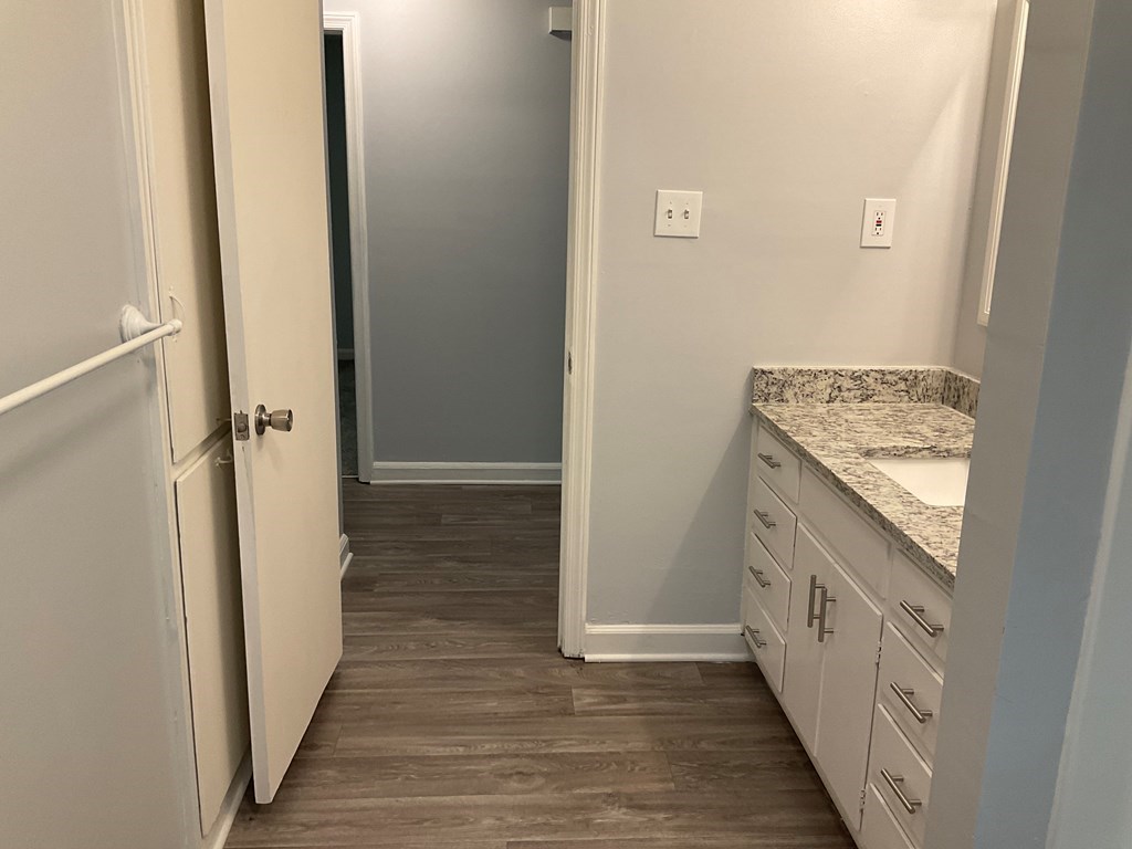 2928 Luckie Street Columbus, GA 31903 - Photo 13 of 32 a bathroom with a granite countertop sink and washing machine