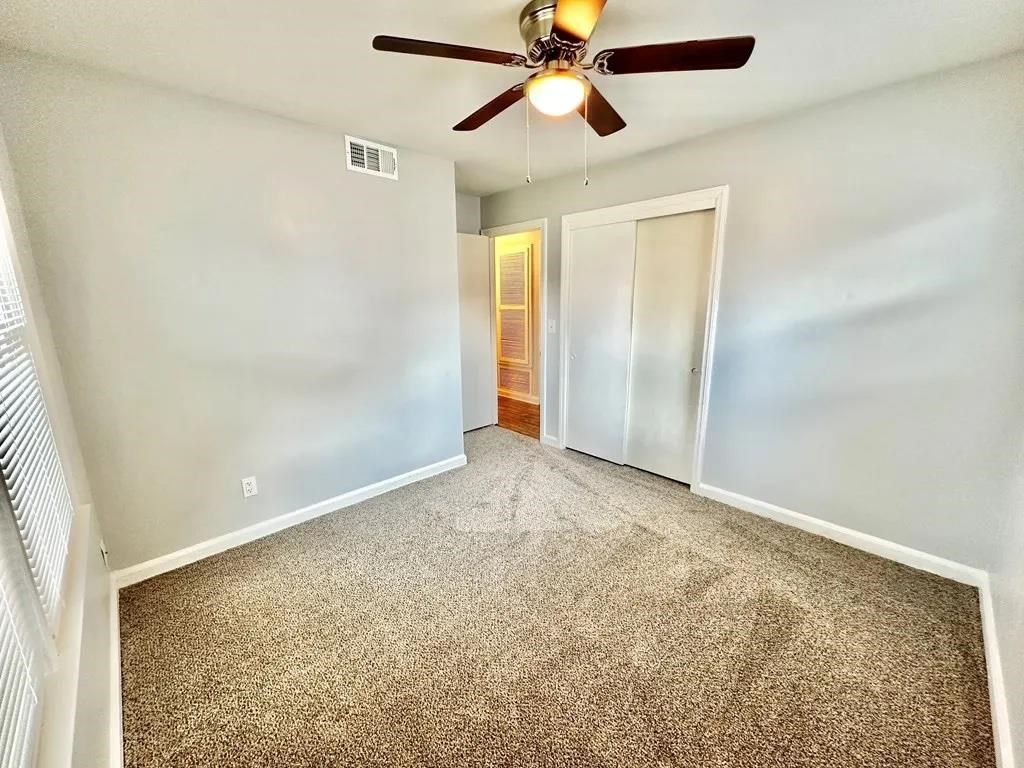 2928 Luckie Street Columbus, GA 31903 - Photo 17 of 32 an empty room with closet and a chandelier fan