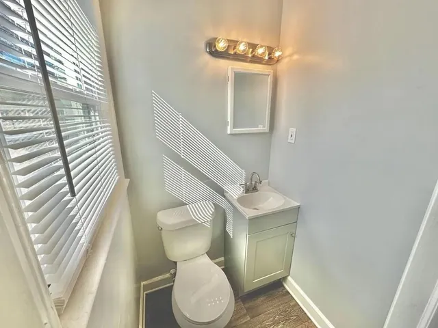 a bathroom with a toilet a sink and mirror