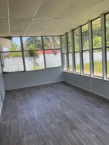 a view of a room with wooden floor