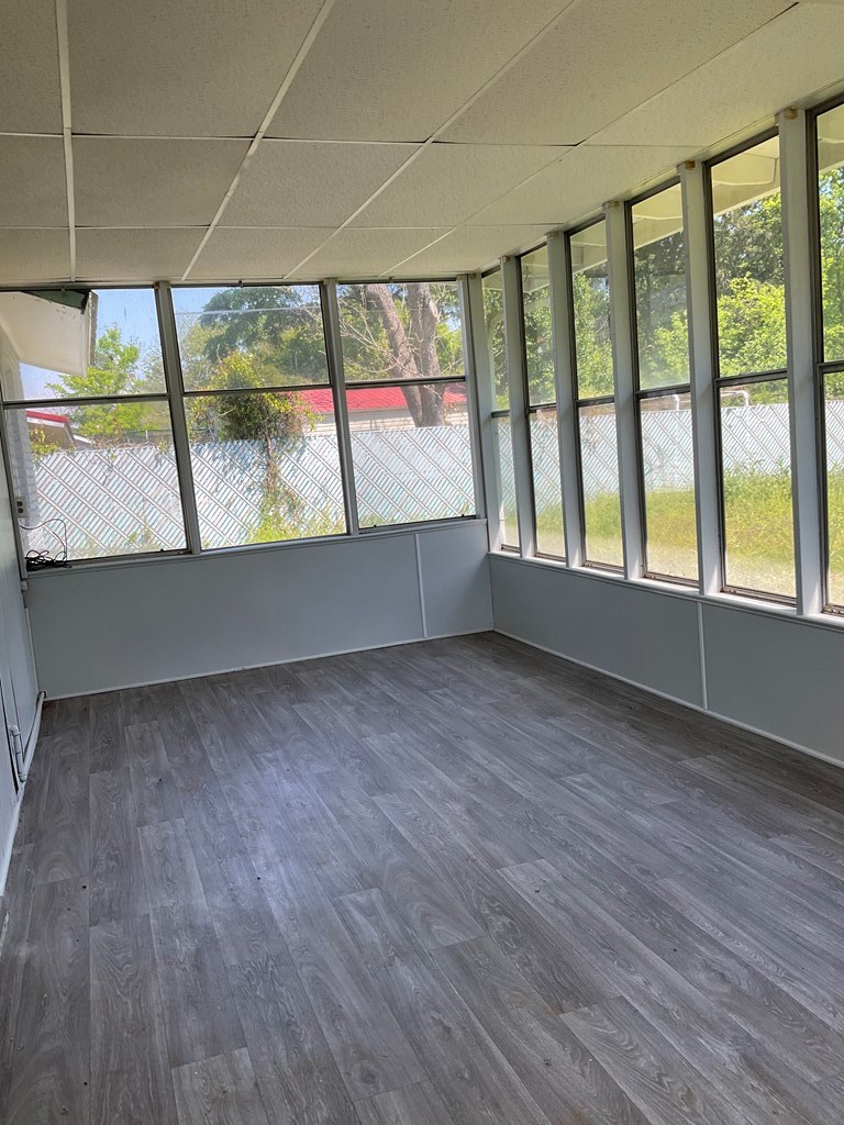 2928 Luckie Street Columbus, GA 31903 - Photo 30 of 32 an empty room with wooden floor and windows