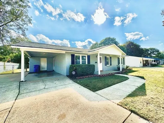a view of a house with a yard and porch