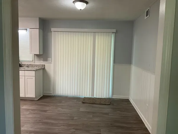 a view of a kitchen with a sink cabinets and wooden floor