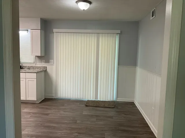 a view of a kitchen with a sink cabinets and wooden floor