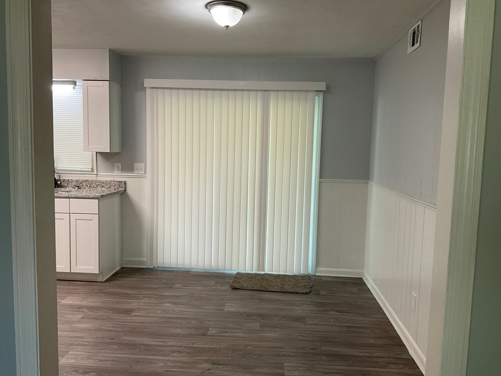 2928 Luckie Street Columbus, GA 31903 - Photo 6 of 32 a view of a kitchen with a sink cabinets and wooden floor