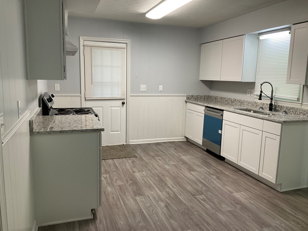 2928 Luckie Street Columbus, GA 31903 - Photo 7 of 32 a kitchen with granite countertop a sink and cabinets