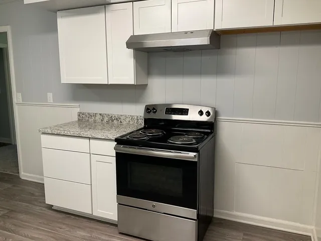 a stove top oven sitting inside of a kitchen