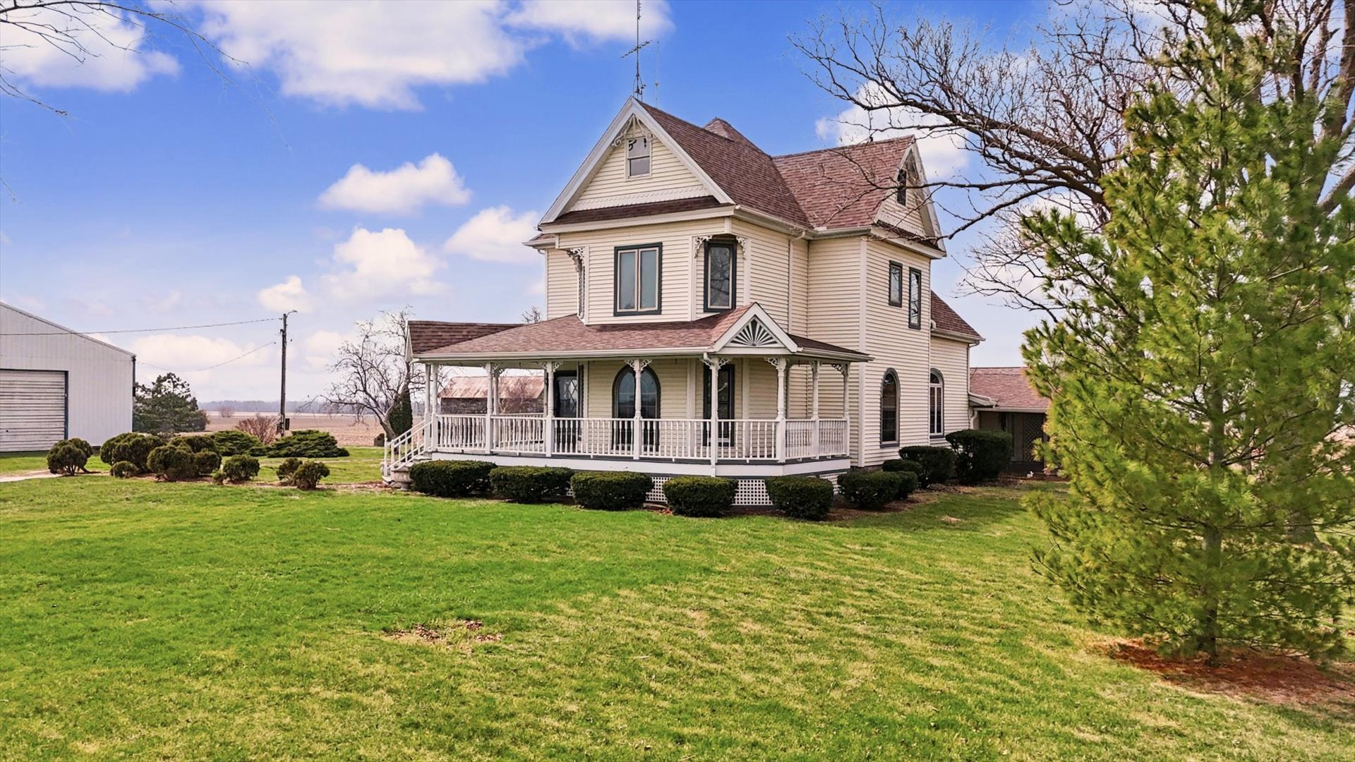 7961 North 3000 E Road Forrest, IL 61741 - Photo 3 of 66 a view of a white house with a big yard and large trees
