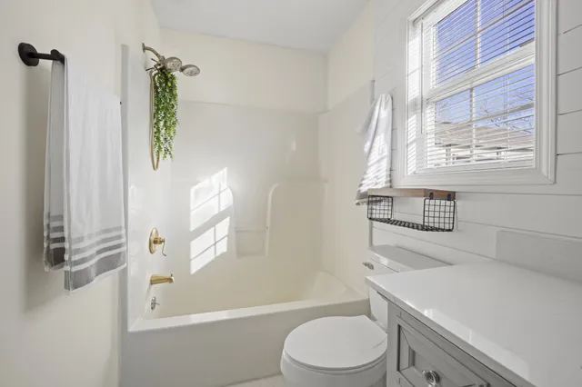 a bathroom with a sink a toilet and a bathtub