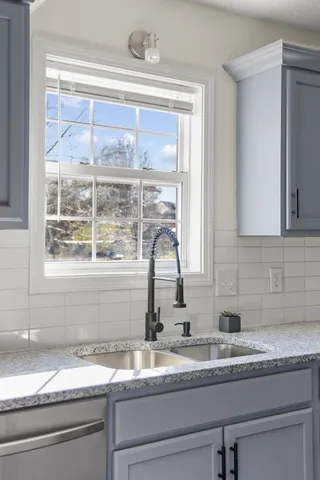 a sink with a granite countertop window