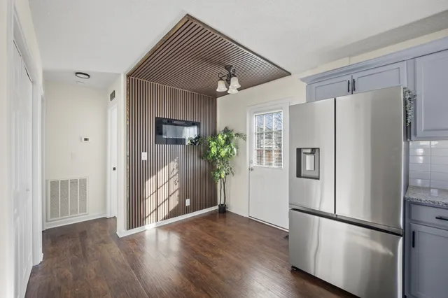 a metallic refrigerator freezer sitting in a kitchen