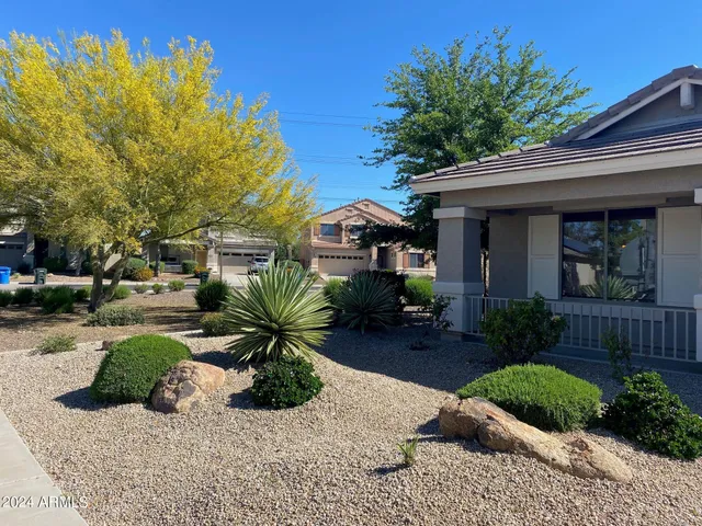 a view of a house with a yard and a garden