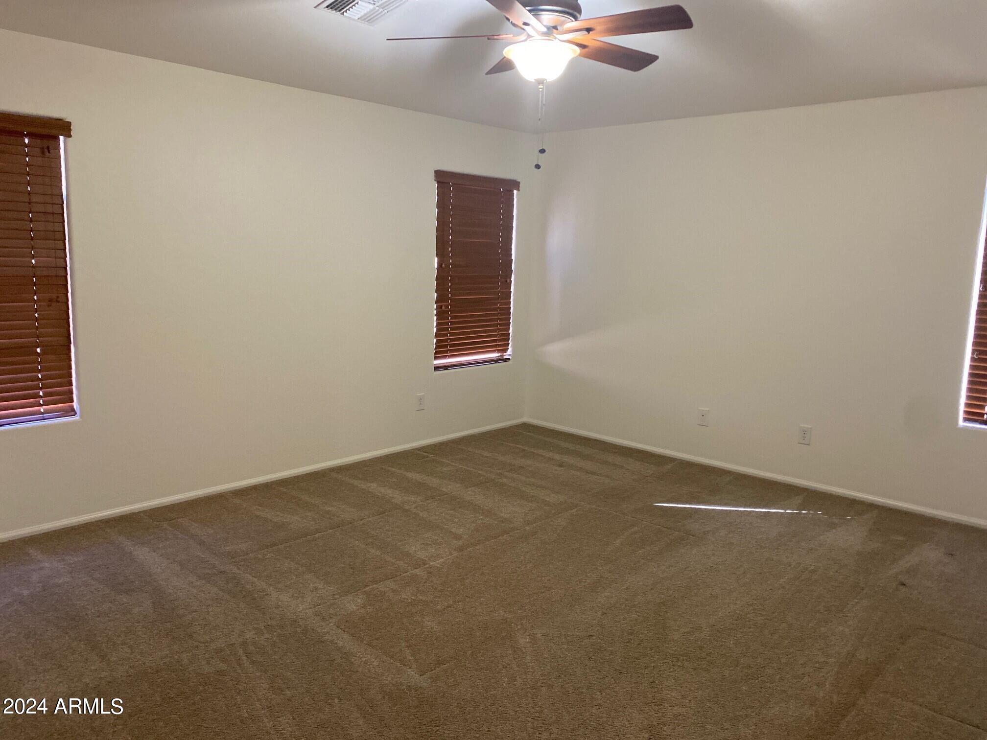 2812 East Questa Drive Phoenix, AZ 85024 - Photo 13 of 32 an empty room with a chandelier fan