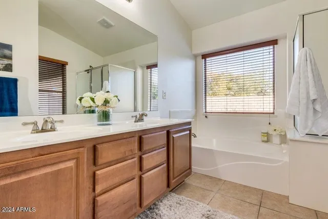 a bathroom with a double vanity sink and a mirror