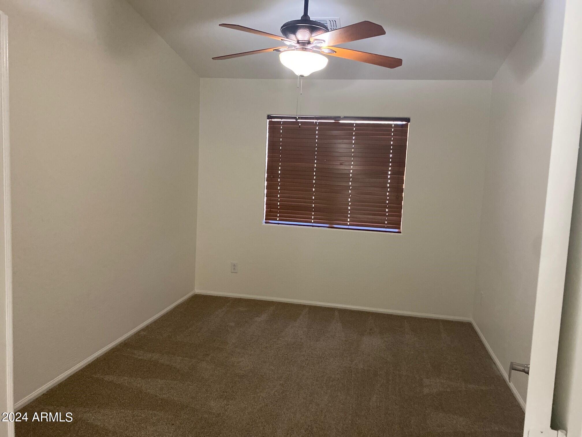 2812 East Questa Drive Phoenix, AZ 85024 - Photo 21 of 32 an empty room with a window and a fan