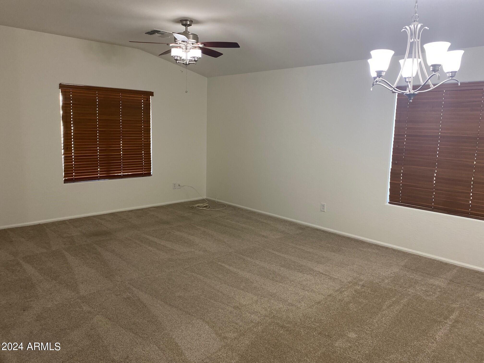 2812 East Questa Drive Phoenix, AZ 85024 - Photo 22 of 32 a view of an empty room with a chandelier fan