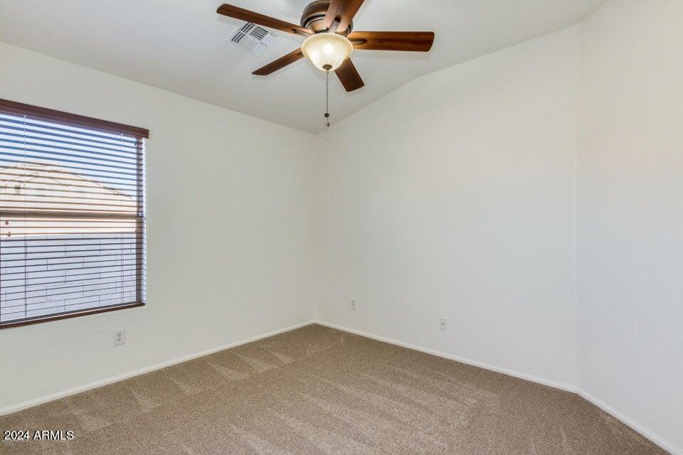 2812 East Questa Drive Phoenix, AZ 85024 - Photo 24 of 32 an empty room with a window and a fan