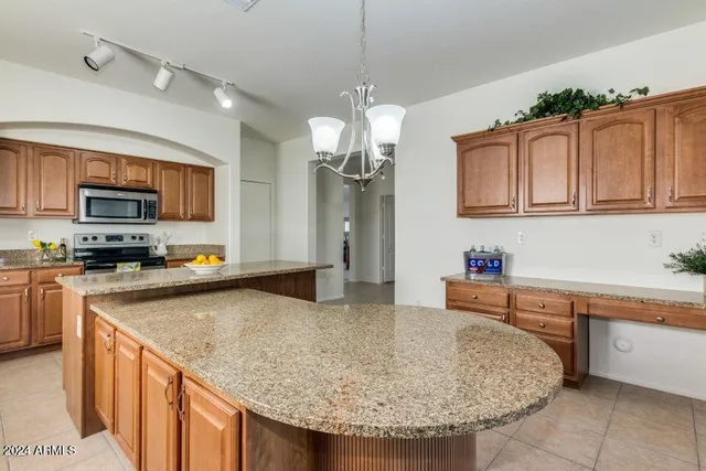 a kitchen with stainless steel appliances granite countertop a sink dishwasher and cabinets with wooden floor
