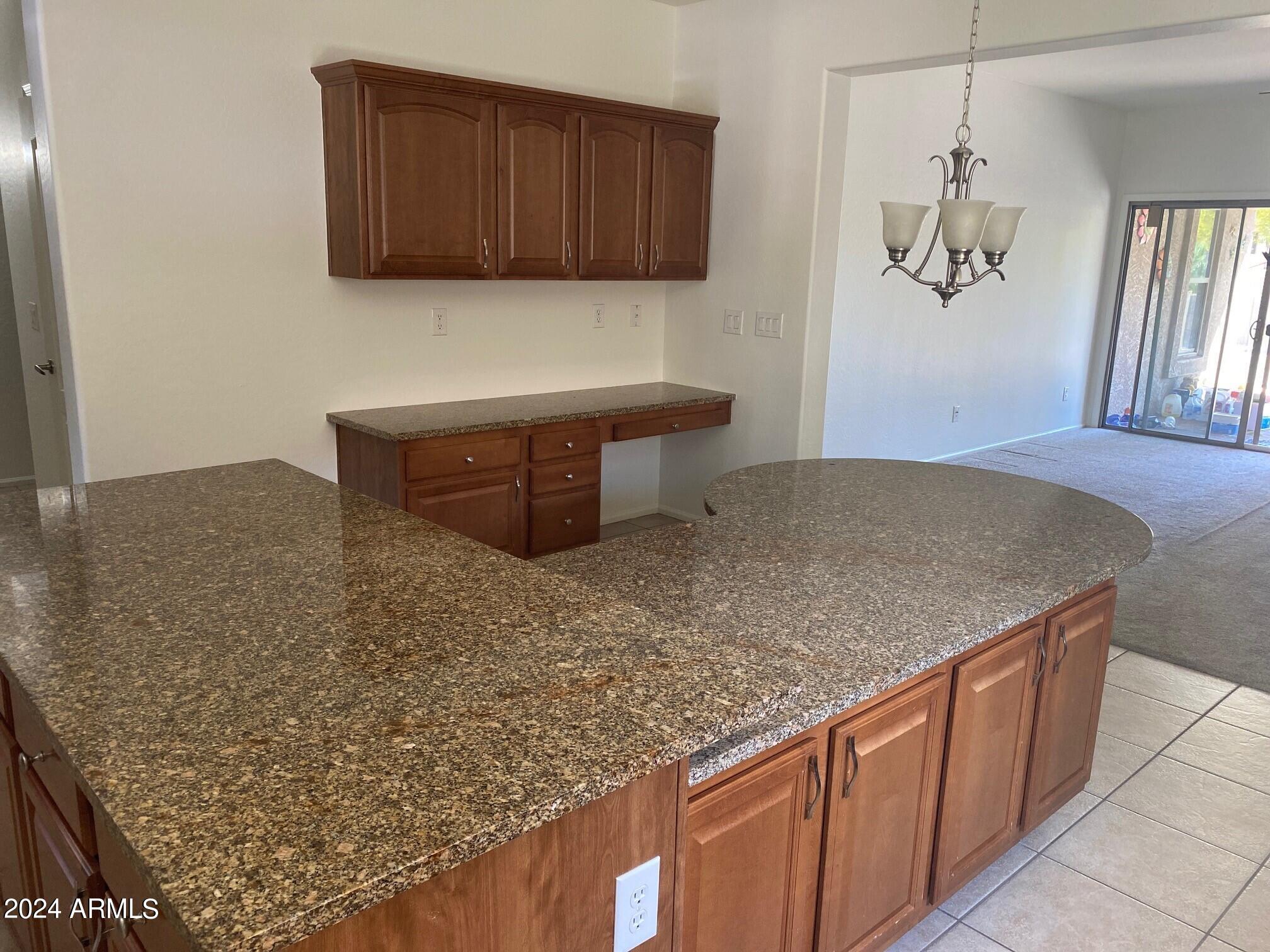 2812 East Questa Drive Phoenix, AZ 85024 - Photo 10 of 32 a kitchen with granite countertop a sink a stove and a wooden cabinets