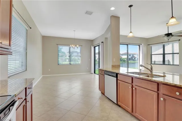 a large kitchen with kitchen island granite countertop a large window and a sink