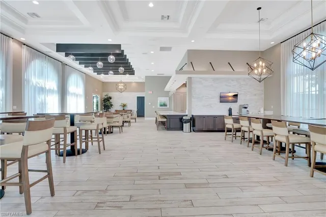 a view of a room with furniture chandelier and wooden floor