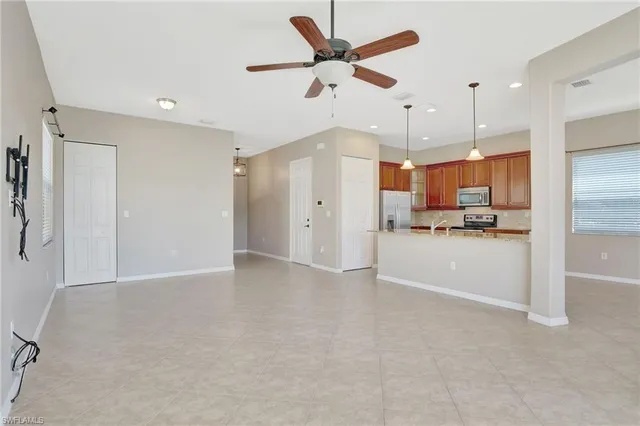 a view of a kitchen with refrigerator and a ceiling fan