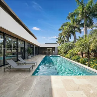 a view of backyard with swimming pool and outdoor seating