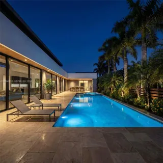 a view of a house with swimming pool and porch with furniture