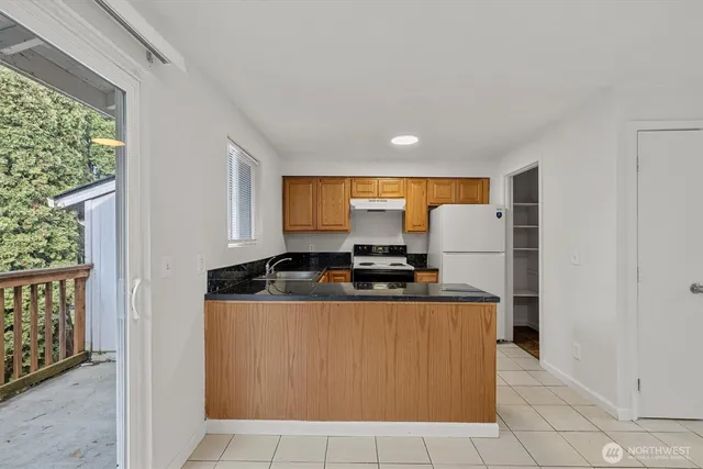 a kitchen with stainless steel appliances granite countertop a stove and a refrigerator
