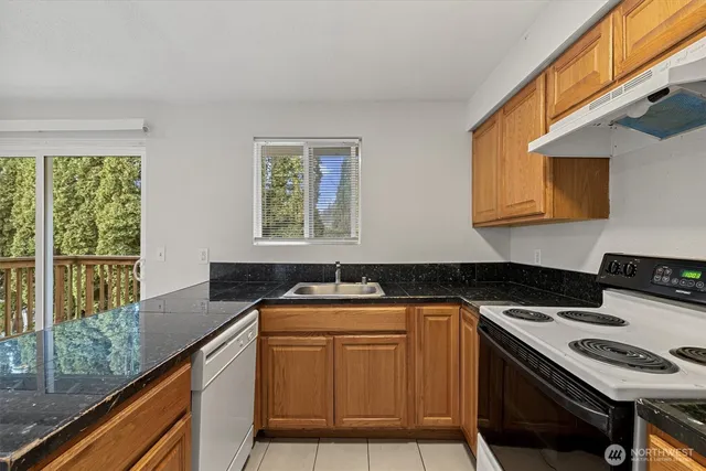 a kitchen that has a sink and a stove