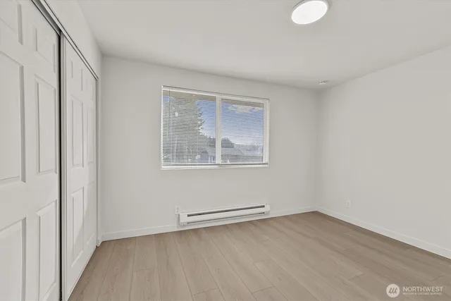 a view of a room with wooden floor and window