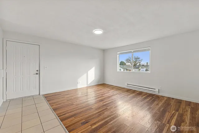 a view of an empty room with wooden floor