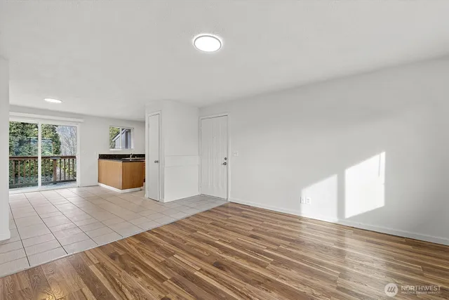 a view of a room with wooden floor and windows