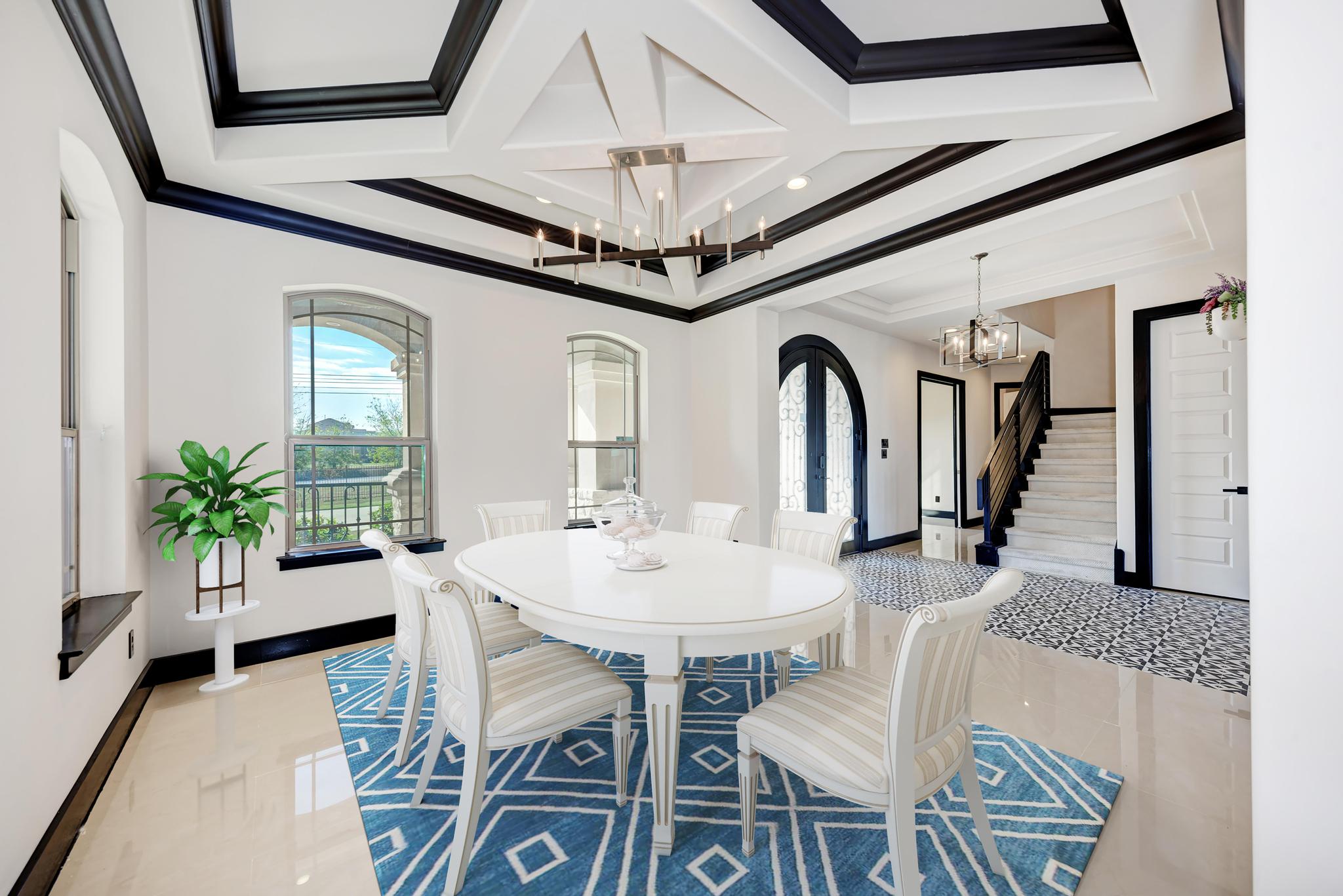 104 Spring Valley Street Hutto, TX 78634 - Photo 10 of 40 Dining room featuring a chandelier, plenty of natural light, crown molding, coffered ceiling, and stairway
