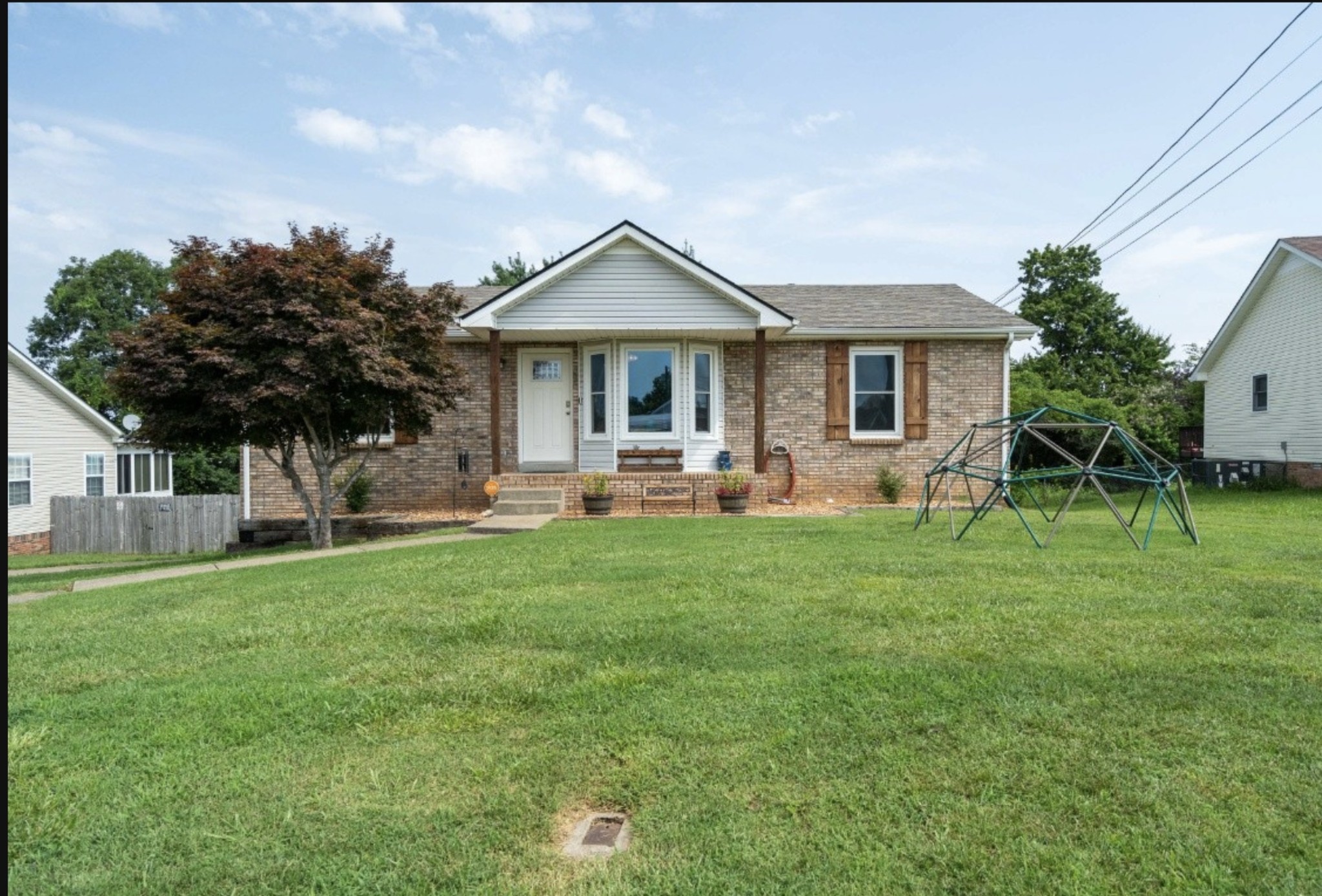 a front view of house with yard and green space